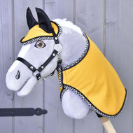 The Hobby Horse LarDen "Set Yellow Beauty" features a plush hobby horse with a gray face, black bridle, yellow fabric coat with black-and-white trim, and a matching blanket, shown against a wooden background.