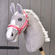 The Hobby Horse LarDen "Halter red stripe with fur" is a gray plush hobby horse with a white mane and red stripe halter on a wooden stick, shown in front of a gray wooden wall.