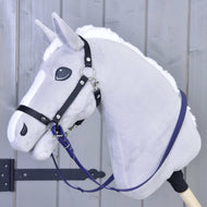 A close-up of a gray plush hobby horse by Hobby Horse LarDen with a black bridle, white mane, and mounted on a wooden stick. It features Reins rubberized Dark purple, shown in front of a light gray wooden background.