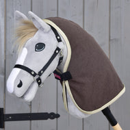 Brown stable blanket with gold trim worn by a grey Hobby Horse with a black halter