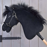 The Hobby Horse LarDen "Hobby Horse Loki with Black Halter" features a plush black Welsh Cob design, white nose markings, and is mounted on a wooden stick—perfect for dressage or imaginative play.