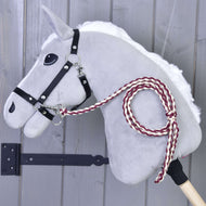 The Hobby Horse LarDen Hobby Horse - Knitted Lead Rope Maroon features a gray felt head with a black bridle and hand-knitted maroon-and-white lead rope, mounted on a wooden stick against a gray wooden wall.