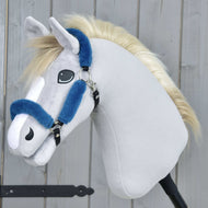The Hobby Horse LarDen Fur Halter Teddy Petrol is a plush hobby horse featuring light gray fabric, a white muzzle, a blond mane, and a blue leatherette halter on a black stick, displayed before a wooden background.