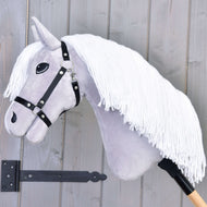 The Hobby Horse LarDen "Popcorn with Black Halter" features gray fabric, a long white yarn mane, and a black halter on a wooden stick, displayed against a light gray wooden wall.