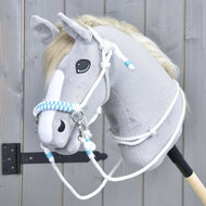 The Hobby Horse LarDen Rope set White Queen features a plush hobby horse head with light gray fur, white mane and face stripe, blue and white braided reins, shown against a wooden fence background.