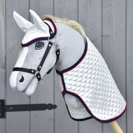 The Set Beautiful Star by Hobby Horse LarDen features a plush hobby horse toy with a white quilted blanket, black bridle, and ear bonnet set, standing by a wooden fence for stylish and protected imaginative play.