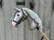 The Hobby Horse Midnight Blue with Black Halter by Hobby Horse LarDen (size S) features a handmade design, a blue fabric head, black halter, and is mounted on a wooden stick.