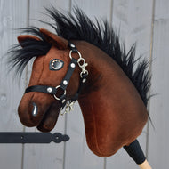 The Hobby Horse LarDen Benny with Black Halter (size XS) features a plush brown Belgian Warmblood head with black mane, white accents, a black halter, and is mounted on a wooden stick—perfect for young show jumping fans.