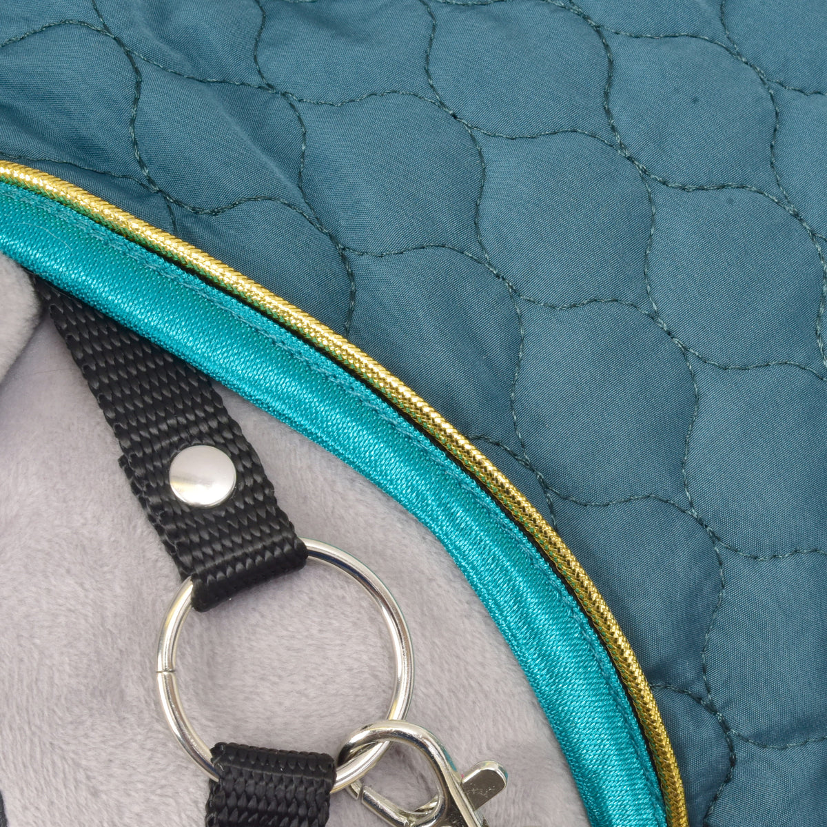 Hobby Horse Blanket with removable neck cover Lagoon close-up with quilted green fabric, turquoise trim and metal ring