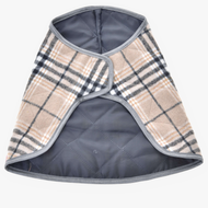 The Blanket Cremo England by Hobby Horse LarDen is a stylish small quilted plaid dog coat in beige, black, and white checks with gray trim and a wrap-around design—ideal for pairing with an ear bonnet for added insect protection. Laid flat on white background.