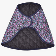 The Blanket Flower by Hobby Horse LarDen is a quilted, cape-style garment with black lining, a dark floral pattern of small blue and purple flowers, and dark blue trim—evoking a cozy horse blanket.