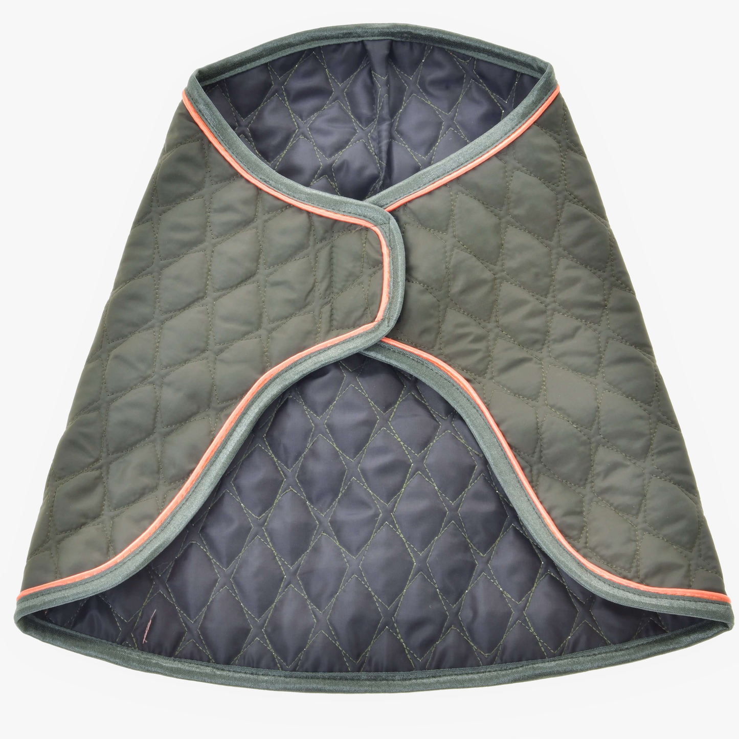 The Blanket Sport by Hobby Horse LarDen is a quilted, dark green dog coat with grey trim and light orange piping, inspired by protective horse blankets. Shown open and flat, it displays a diamond-stitched pattern and curved edges.