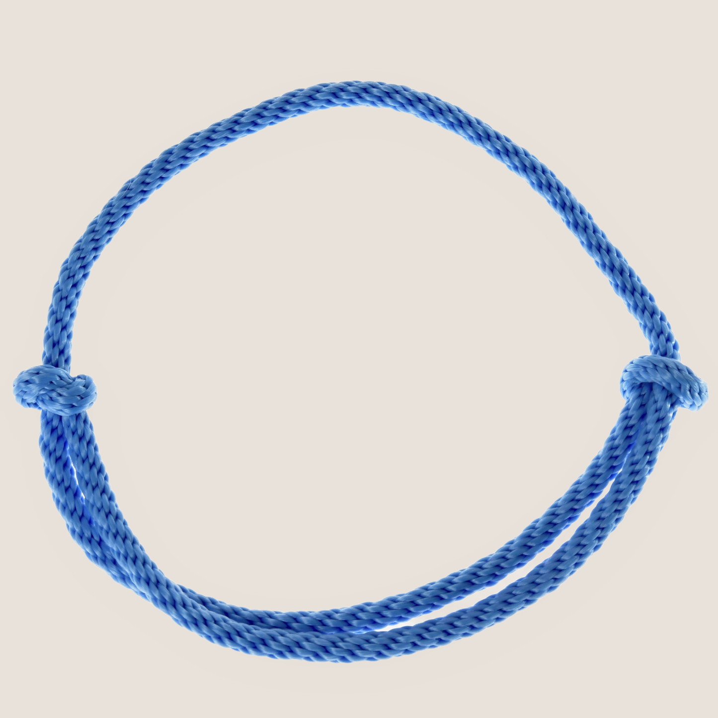The Cordeo Sky by Hobby Horse LarDen is a blue braided rope handmade cordeo in a simple closed loop with two knots on opposite sides, shown on a white background. Ideal for hobby horse riding or bitless riding.