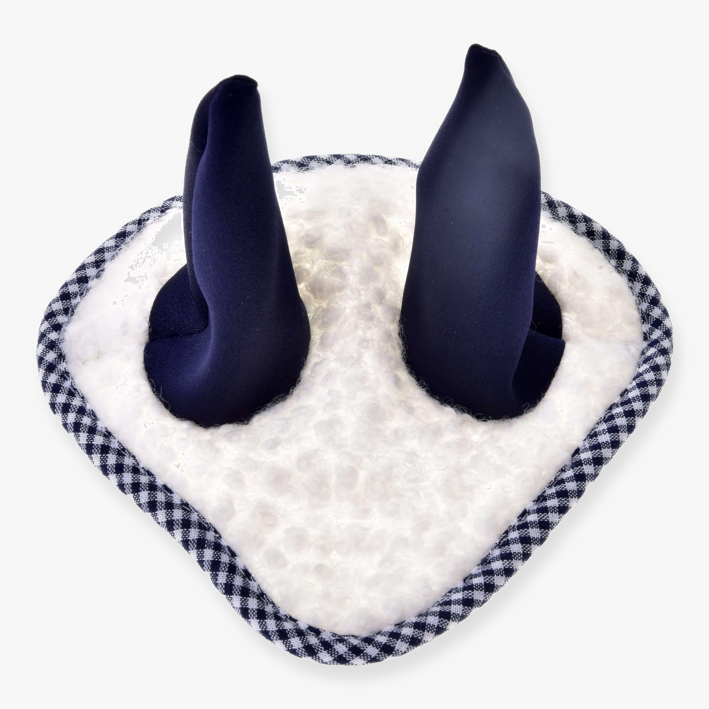 A close-up of the Hobby Horse LarDen Ear Bonnet Cube Blue, featuring soft navy ear-like protrusions on a white fuzzy base with black and white checkered trim for stylish horse insect protection.